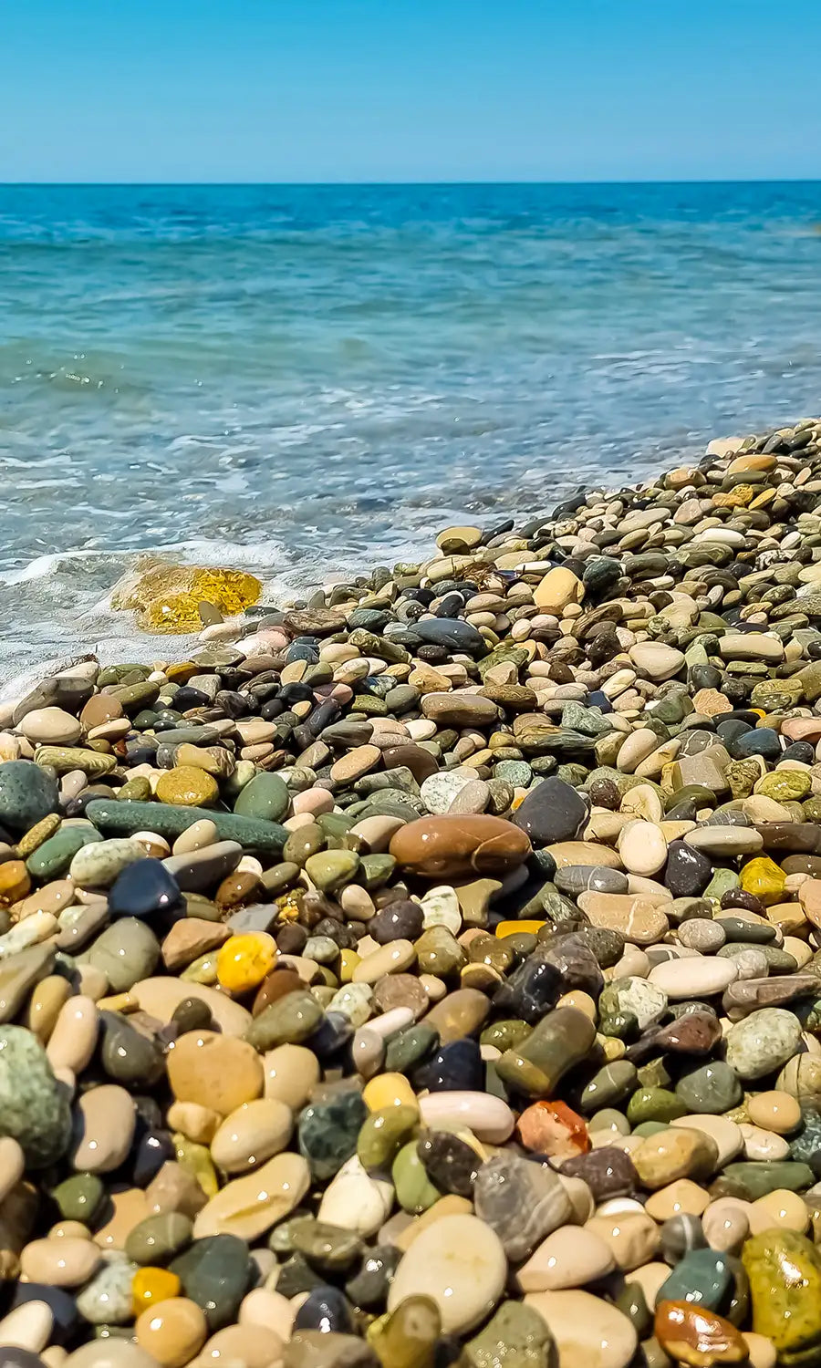 stone beach with bright blue water