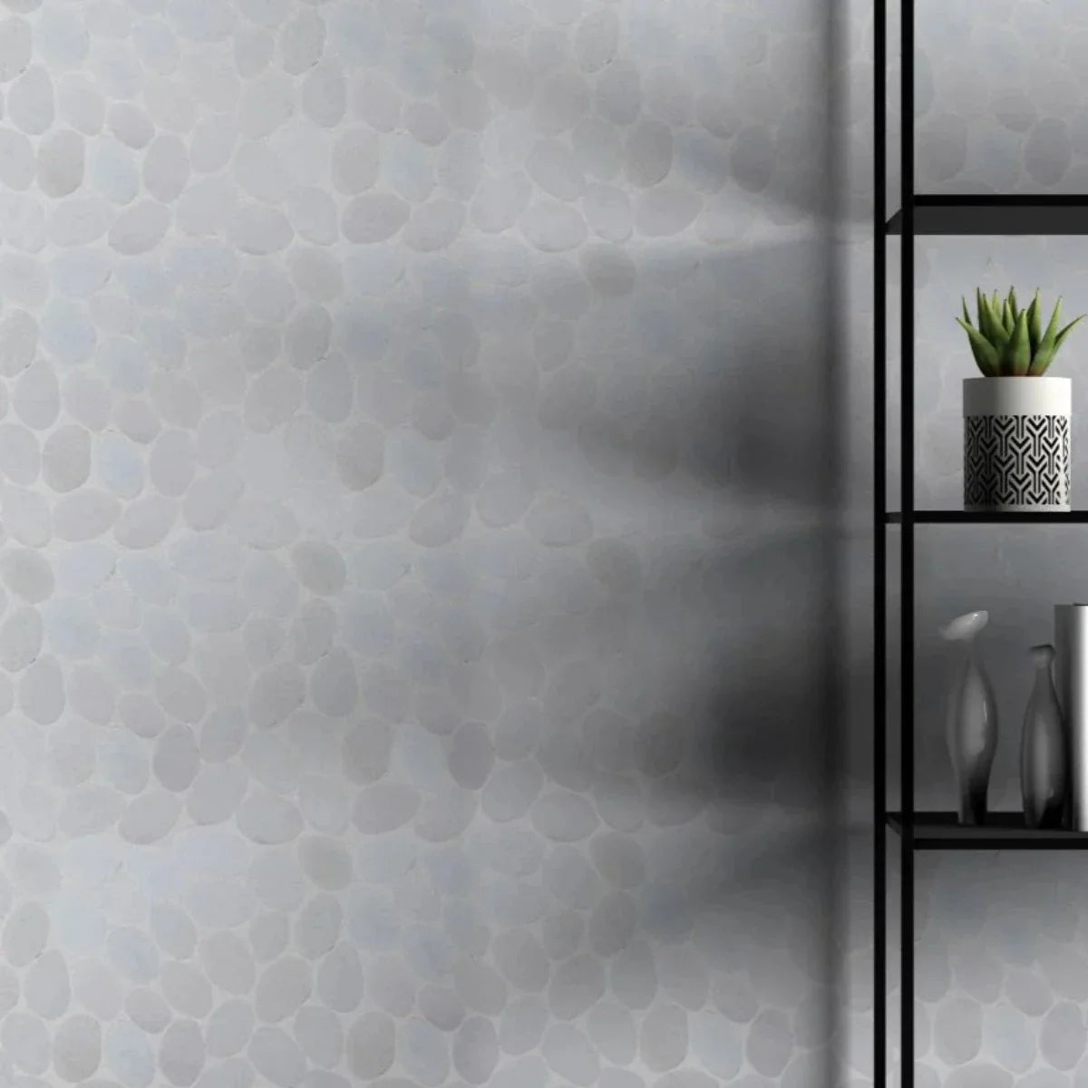 snow white Pebble Tile wall behind wire bookshelf