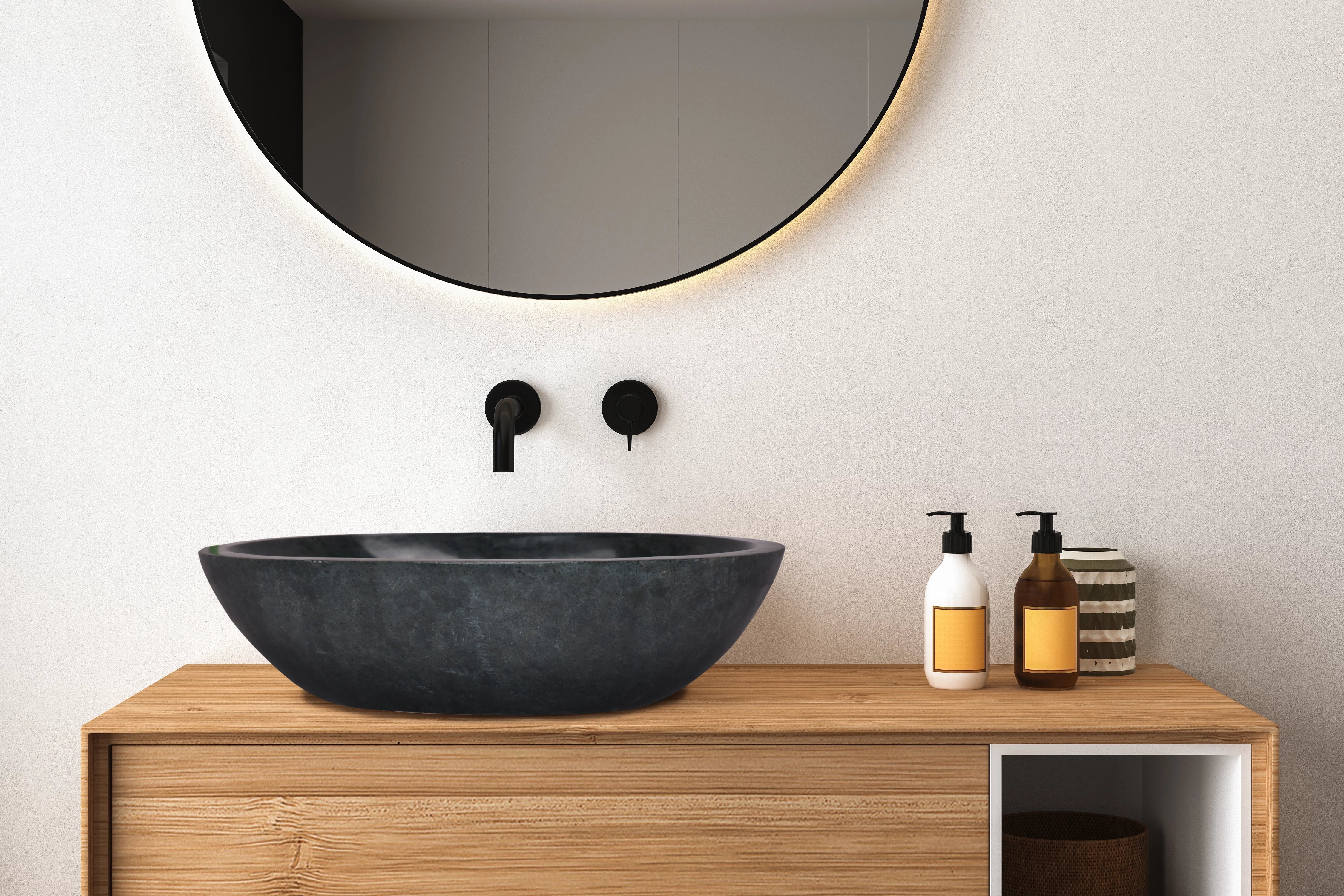 Black Natural basin in bathroom on top of wood armoire 